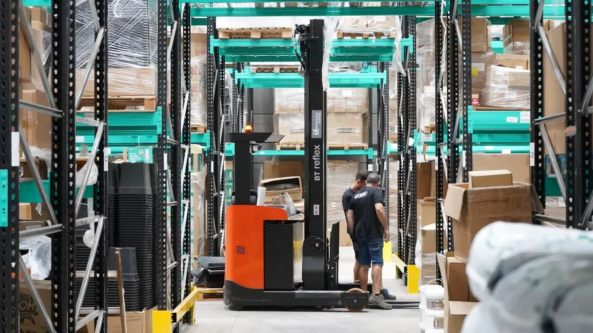 Workers consolidating cargo in a China warehouse
